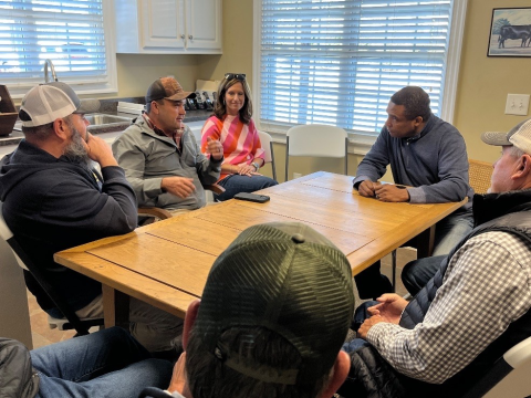 [Congressman Don Davis sits down with tobacco farmers to discuss trade disputes and federal support.]